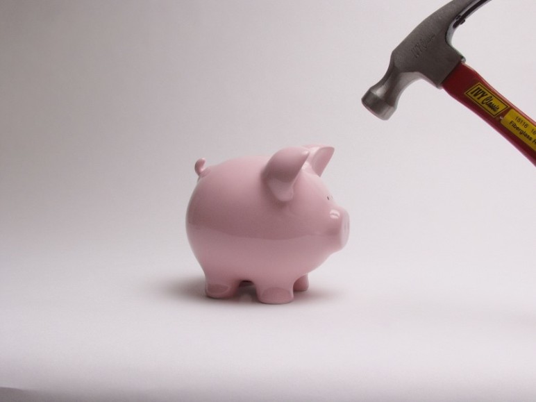 Hammer-about-to-smash-piggy-bank-by-seniorplanning.org-cc.-772x579